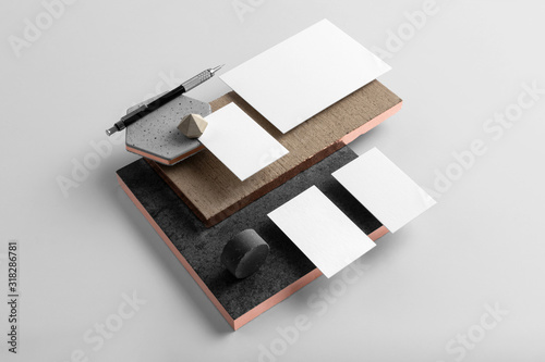 Real photo, stationery branding mockup template to place your design, isolated on light grey background, with concrete, copper, granite and floral elements.