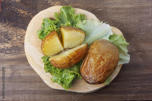 hot baked potato on rustic wooden table
