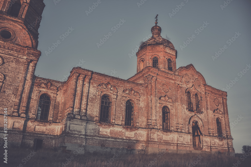 An ancient abandoned and ruined Church, crumbling red brick temple, An abandoned red brick temple illuminated by sunset sun, an abandoned church at sunset