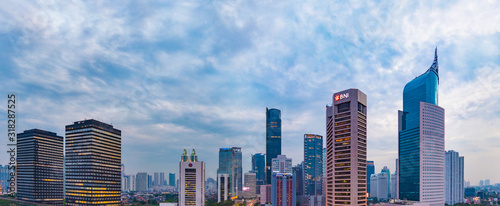 Jakarta, Indonesia - 21 Sept 2018: Aerial view of Jakarta's Central Business District (Sudirman and Kuningan) at a cloudy sunset. Jakarta cityscape at sunset. Panorama/widescreen photo.