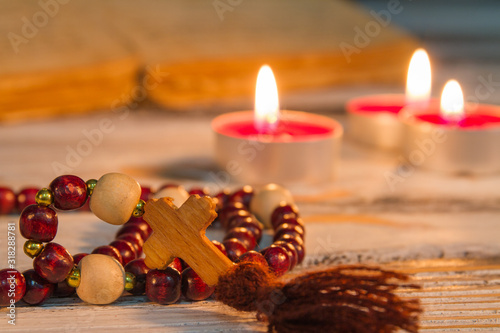 Prayer beads rosary with wooden cross closeup. Divine service, reading manuscript, God praying rithual. photo