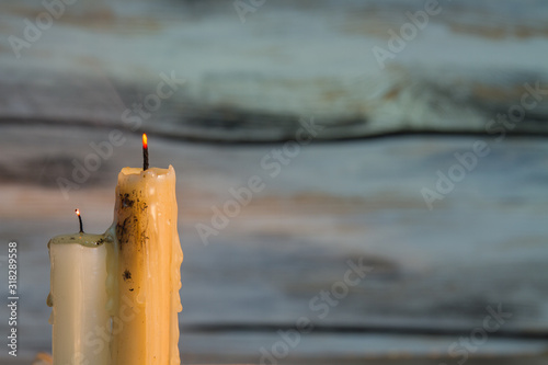 Slika na platnu Two dirty extinguished candles on wooden background