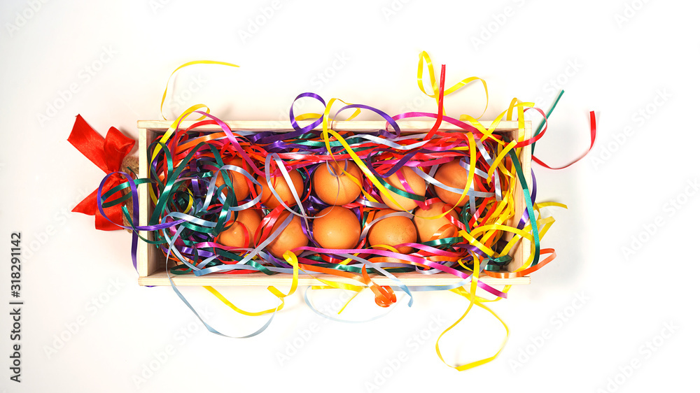 Creative layout made of white chicken eggs in wooden box with colorful confetti with trendy neon colors on white background Creative layout made of white chicken eggs in wooden box with colorful confetti with trendy neon colors on white background