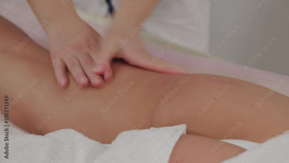 Woman massage therapist does massage on the legs of a young girl in a massage parlor. Woman massage therapist does massage on the legs of a young girl in a massage parlor.