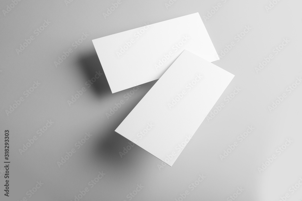 Real photo, business card mockup template, front and back, isolated on light grey background to place your design. Real photo, business card mockup template, front and back, isolated on light grey background to place your design.