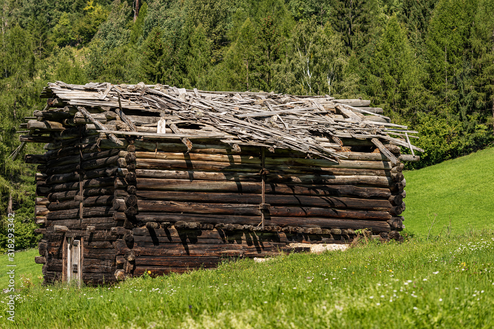 Close-up of an old wooden barn with broken roof in mountain, Val di Fiemme, Bellamonte village, Predazzo, Trentino Alto Adige, Italy, Europe Close-up of an old wooden barn with broken roof in mountain, Val di Fiemme, Bellamonte village, Predazzo, Trentino Alto Adige, Italy, Europe