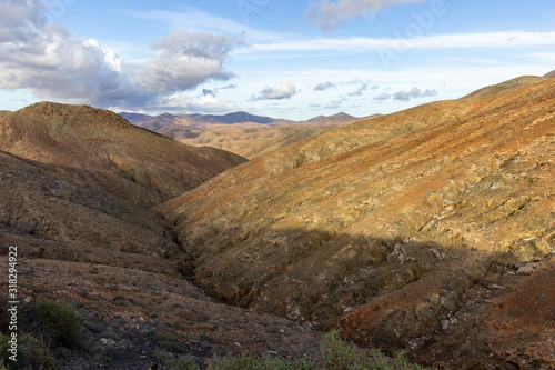 Panoramic view at landscape between Betancuria and Pajara on Fuerteventura with multi colored volcanic hills and mountains