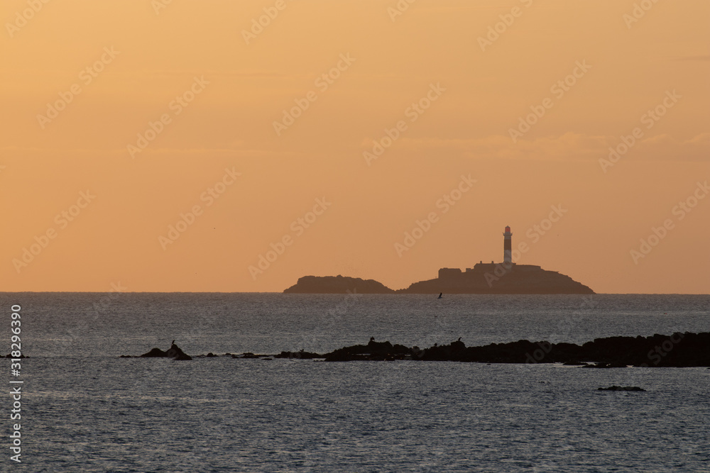 Lighthouse harbour Skerries during day and evening, Co Dublin, Ireland. Rockabill lighthouse on island in distance, golden hour sunrise, Skerries, Ireland