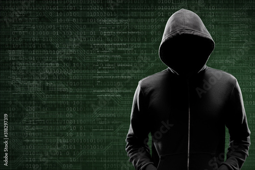 Bilde på lerret Computer hacker in mask and hoodie over abstract binary background