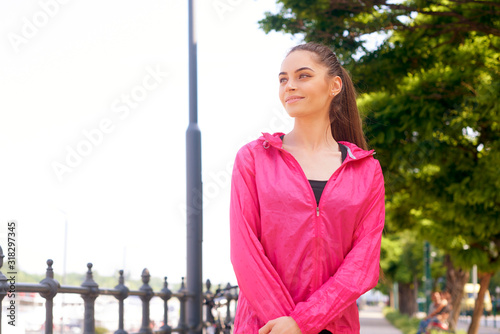 Young woman relaxing agter morning workout in the street photo