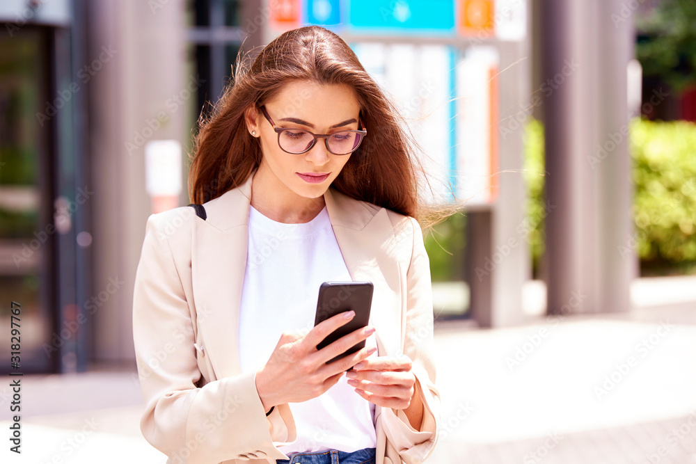 Young businesswoman text messaging on the street Young businesswoman text messaging on the street
