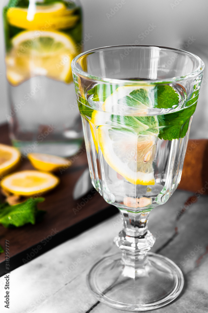 Fresh lemonade with mint in a glass jug on a white background Fresh lemonade with mint in a glass jug on a white background