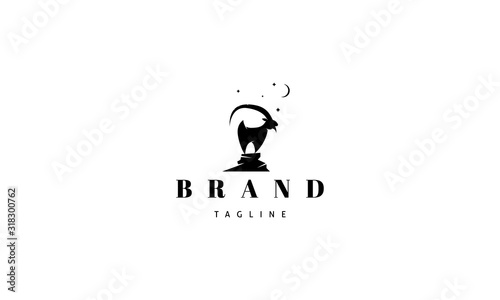 Vector logo on which an abstract image of a goat standing on a rock.