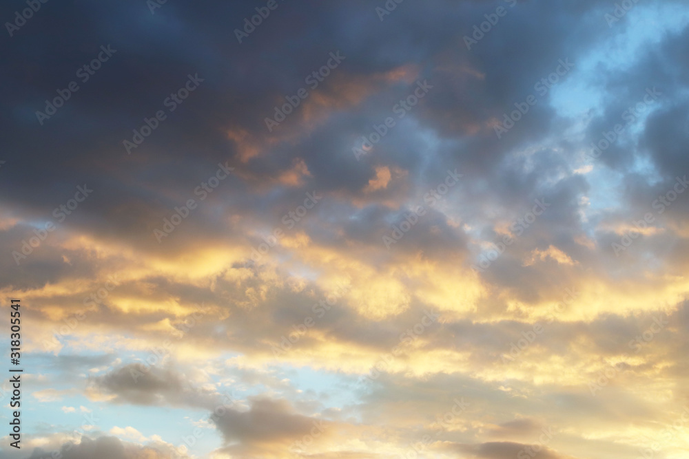 Sunset in the evening sky with golden clouds in the evening. Natural background for later design. Prediction of weather on the circulation of water in the atmosphere. Romantic mood