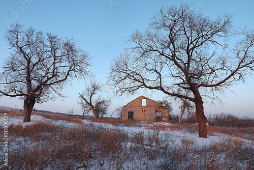 A destroyed building on a farm in the countryside in winter. © Viktor