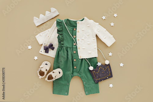 Konstfotografi Green romper with knitted jumper, kids handbag, cotton crown and baby boots