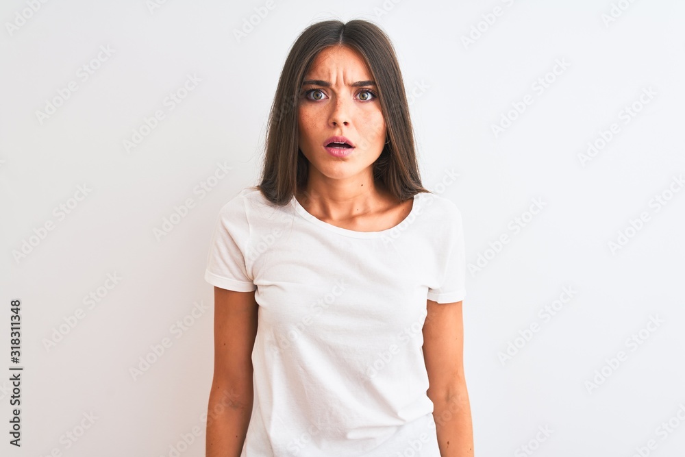 Young beautiful woman wearing casual t-shirt standing over isolated white background afraid and shocked with surprise and amazed expression, fear and excited face. Young beautiful woman wearing casual t-shirt standing over isolated white background afraid and shocked with surprise and amazed expression, fear and excited face.