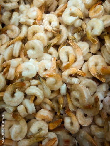 boiled frozen tails of tiger (large) shrimps in a supermarket freezer counter awaiting buyers