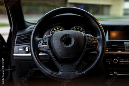 interior of a modern car with steering wheel © Shkriabii