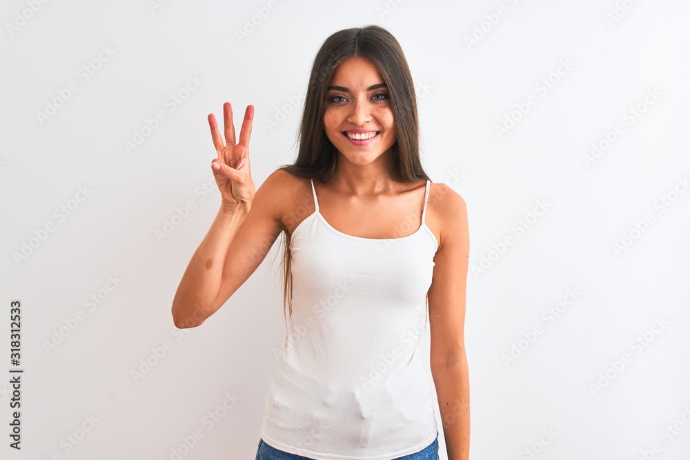 Young beautiful woman wearing casual t-shirt standing over isolated white background showing and pointing up with fingers number three while smiling confident and happy. Young beautiful woman wearing casual t-shirt standing over isolated white background showing and pointing up with fingers number three while smiling confident and happy.