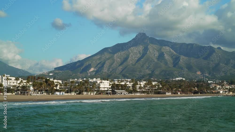 Gimbal shot of Marbella La Concha mountain left to right and the seaside at daylight. Sea coast in the marina of Luxury yacht of Puerto Banus located in Spain Gimbal shot of Marbella La Concha mountain left to right and the seaside at daylight. Sea coast in the marina of Luxury yacht of Puerto Banus located in Spain