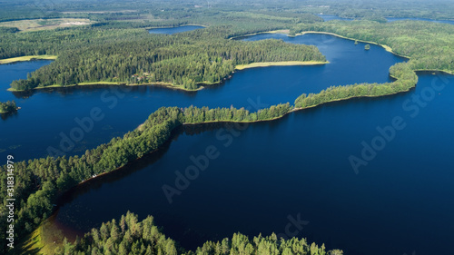 Aerial view of beautiful blue lake Liesjarvi in Finland.  Blue lakes  islands and green forests from above on a summer morning. 