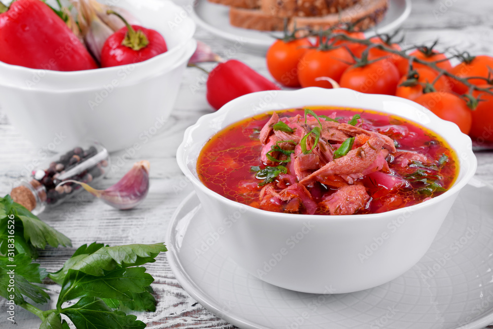 Borscht soup with meat in a white bowl. Ukrainian cuisine meal Borscht soup with meat in a white bowl. Ukrainian cuisine meal