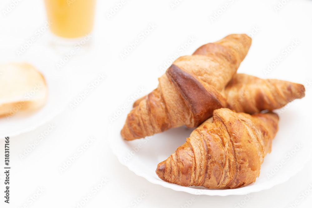Croissants on a white plate. Breakfast is delicious and healthy. Croissants on a white plate. Breakfast is delicious and healthy.