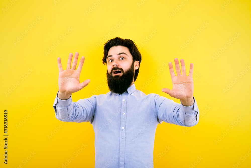 man with hands up fear