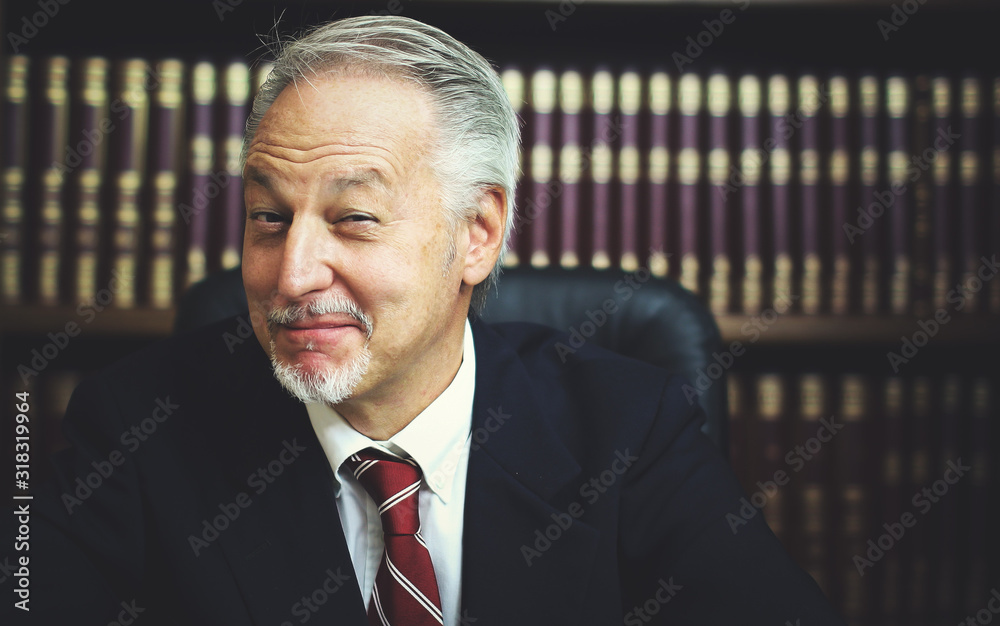 Naklejka premium Portrait of smiling senior businessman in his library