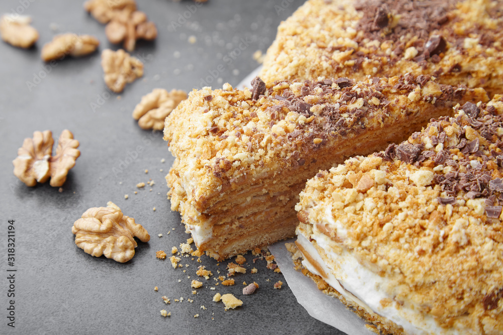 baked pie with cream and nut crumbs, a slice of delicious pastries on a dark background