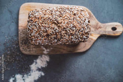 Bio bread with multi seeds on wooden table. Top view. photo