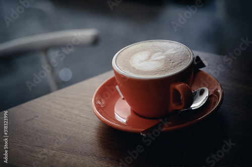 cup of coffee on wooden table in a cafe