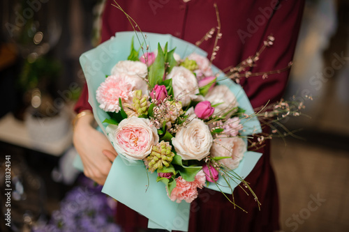Wallpaper Mural Woman holding a spring bouquet of tender pink roses, tulips and carnations decorated with green leaves Torontodigital.ca