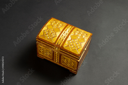 Closed single casket isolated on black with soft shadows, wooden box, wooden chest, treasure chest. photo