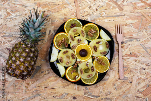 Natural fruit dessert with hazelnuts and walnuts on the table. photo