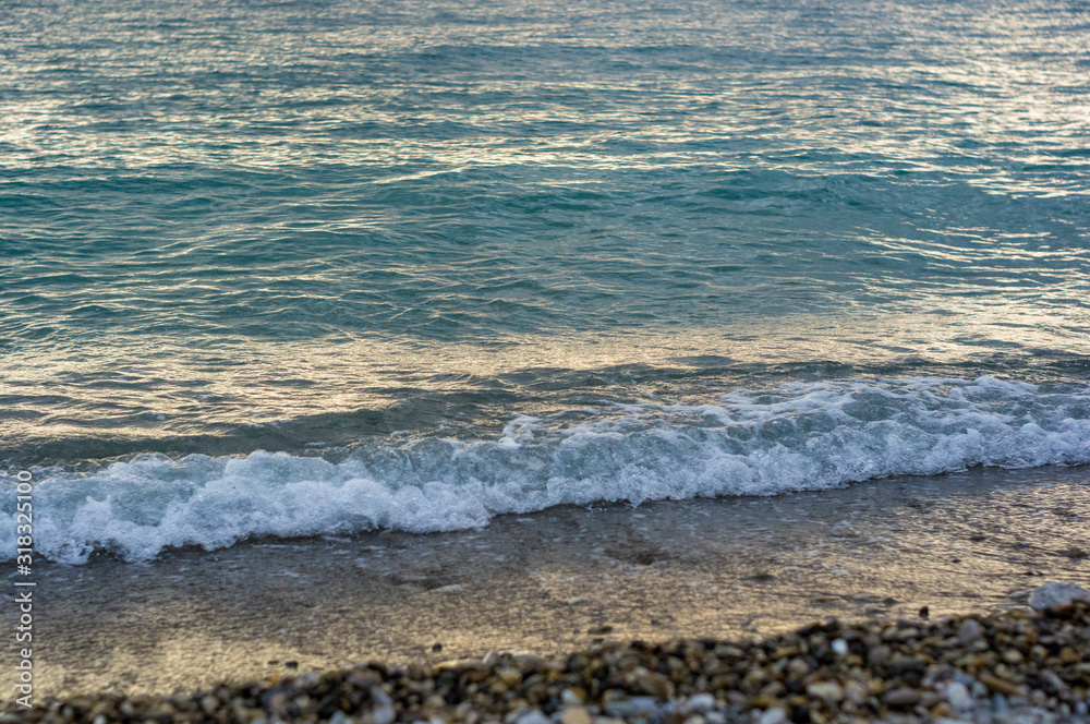 sea landscape is a pebbly beach with waves in white foam sea landscape is a pebbly beach with waves in white foam
