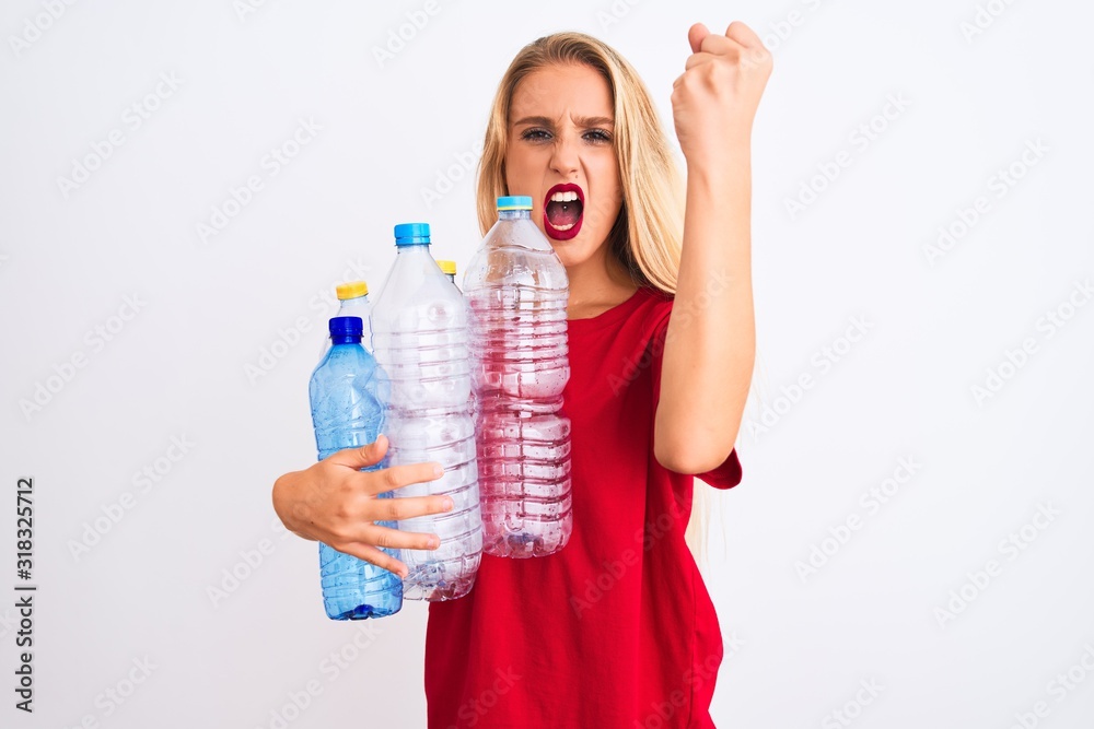 Young beautiful woman recycling plastic bottles standing over isolated white background annoyed and frustrated shouting with anger, crazy and yelling with raised hand, anger concept Young beautiful woman recycling plastic bottles standing over isolated white background annoyed and frustrated shouting with anger, crazy and yelling with raised hand, anger concept