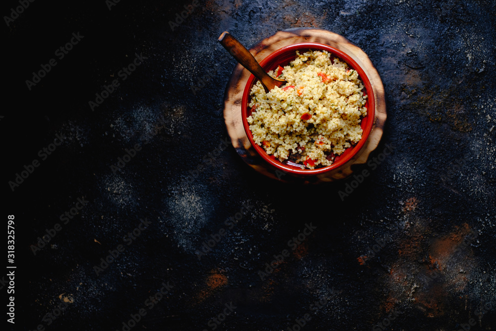 Tabule. Arabian vegetarian salad with couscous. Dark background. Isolated