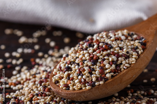 mix of quinoa grains on dark wooden rustic background photo