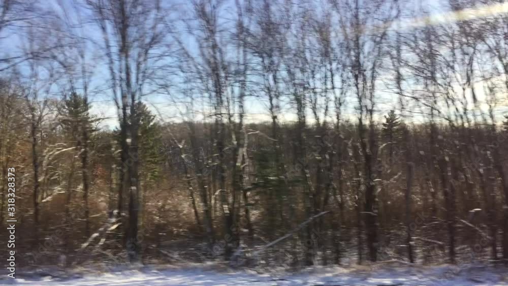winter snow covered typical countryside in Massachusetts between New York and Boston road trip view from car on freeway winter snow covered typical countryside in Massachusetts between New York and Boston road trip view from car on freeway