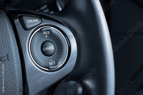 Foto Cruise control button switch on steering wheel in a luxury car,automotive part concept