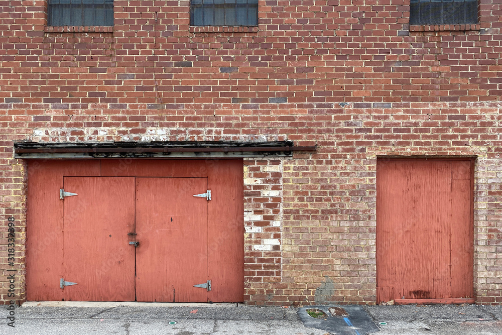 abandoned warehouse alley brick wall red doors