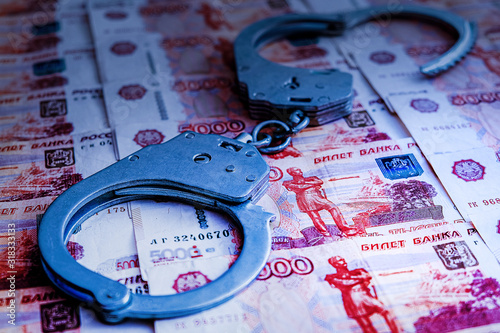 High-profile arrest of a high-ranking official for bribery. Money and handcuffs. Law and crime. Illicit enrichment. photo