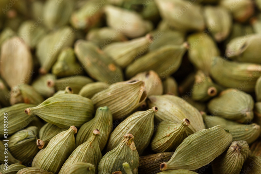 fragrant green cardamom on a white acrylic background fragrant green cardamom on a white acrylic background