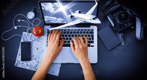 The plane fly out of the computer . Online travel booking concept.