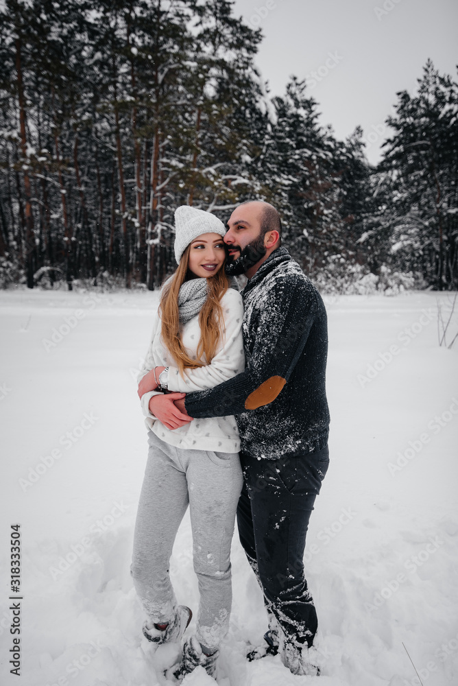 Couple playing with snow in the forest Couple playing with snow in the forest