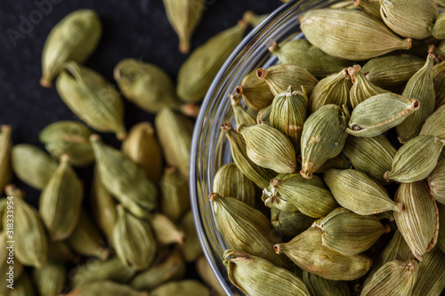 fragrant green cardamom on a dark stone background
