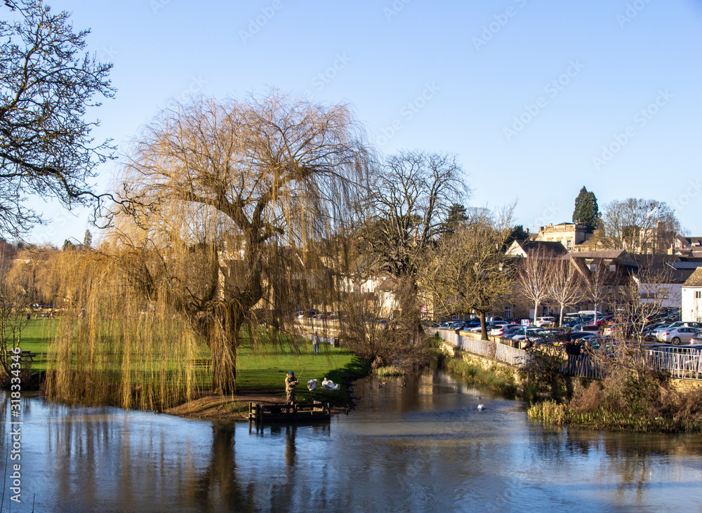 Fisherman on the river welland in the beauitiful lincolnshire town of stamford landscape.