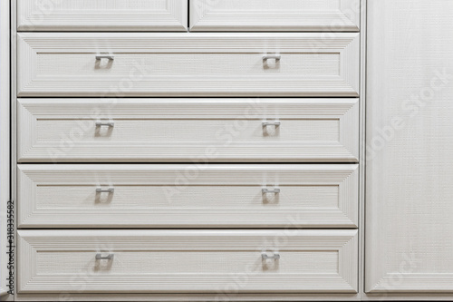part of facade of wooden dresser, modern design chest of drawers, commode with four boxes, home storage system